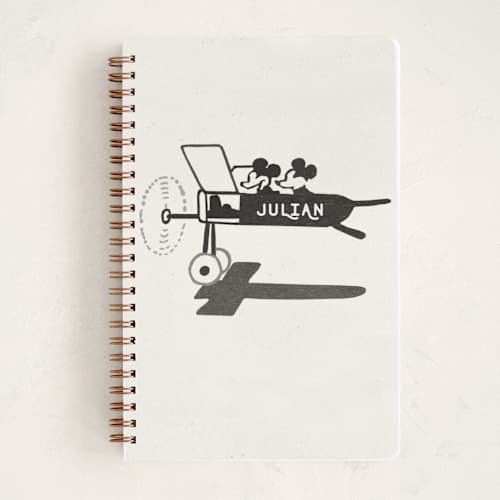 This is a ivory journals with standard by Sumak Studio called disney's mickey and minnie on the plane printing on premium cover stock in notebook