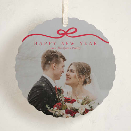 This is a cardinal holiday card ornaments with standard by Kaydi Bishop called bow tied printing on recycled smooth signature in ornament