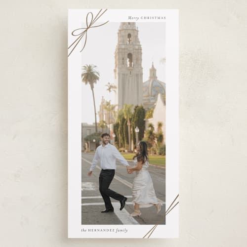 This is a snow foil pressed holiday cards with foil pressed by Heather Schertzer called tied with ribbon printing on recycled smooth signature in tall