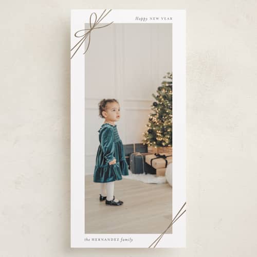 This is a snow foil pressed holiday cards with foil pressed by Heather Schertzer called tied with ribbon printing on recycled smooth signature in tall