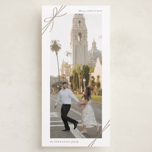This is a snow holiday photo cards with standard by Heather Schertzer called tied with ribbon printing on recycled smooth signature in tall
