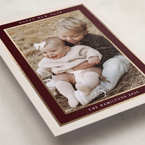 This is a maroon foil pressed holiday cards with foil pressed by Nicole Walsh called encompass printing on recycled smooth signature in standard