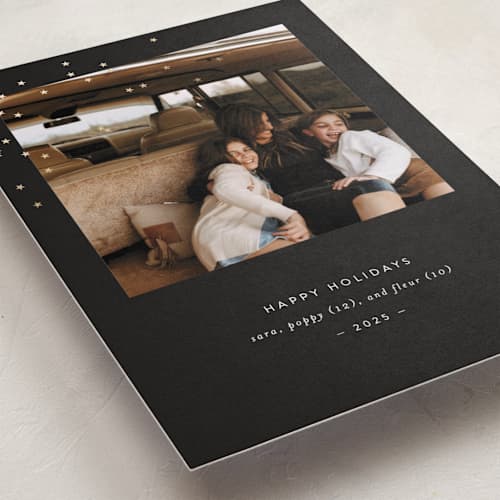 This is a ebony foil pressed holiday cards with foil pressed by Bramble Studio called starry eyed printing on recycled smooth signature in standard