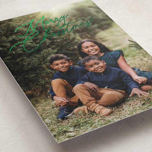 This is a sage foil pressed holiday cards with foil pressed by Melanie Kosuge called merry monoline printing on recycled smooth signature in standard