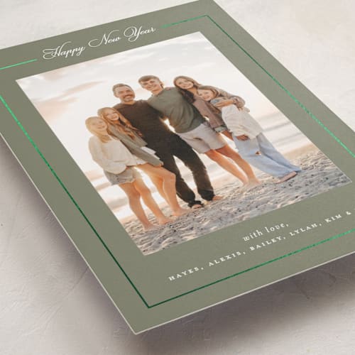 This is a sage foil pressed holiday cards with foil pressed by Melanie Kosuge called greenwich printing on recycled smooth signature in standard