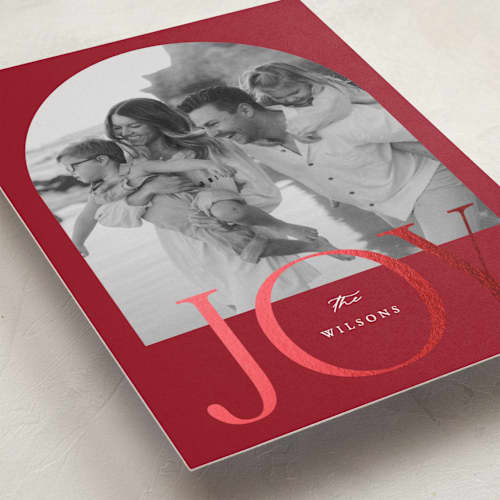 This is a cranberry foil pressed holiday cards with foil pressed by Brianne Larsen called joy arch printing on recycled smooth signature in standard