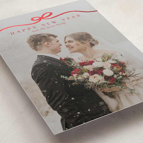 This is a cardinal foil pressed holiday cards with foil pressed by Kaydi Bishop called bow tied printing on recycled smooth signature in standard