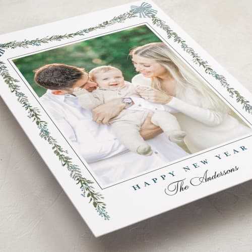 This is a winter berry foil pressed holiday cards with foil pressed by Susan Moyal called holly & bows printing on recycled smooth signature in standard
