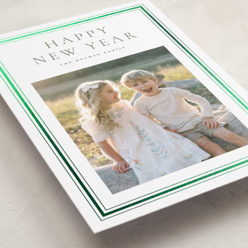 This is a pine foil pressed holiday cards with foil pressed by Wildfield Paper Co called eucalyptus printing on recycled smooth signature in standard