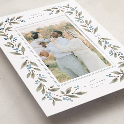 This is a juniper berry foil pressed holiday cards with foil pressed by Wildfield Paper Co called poinsettia + pine printing on recycled smooth signature in standard