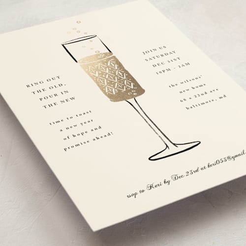 This is a cream holiday party invitations with foil pressed by mo kelley called champagne flute printing on signature in standard