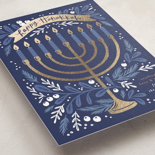 This is a navy hanukkah cards with foil pressed by Alethea and Ruth called hanukkah greenery printing on signature in standard