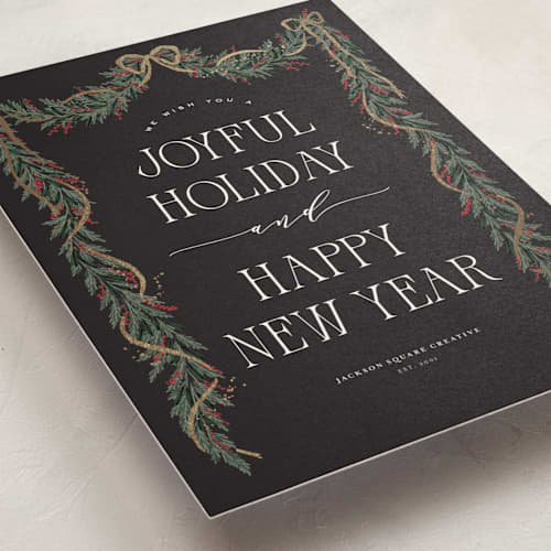 This is a charcoal business holiday cards with foil pressed by Leah Bisch called holly garland printing on signature in standard
