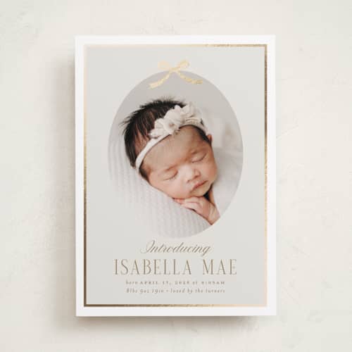 This is a cashmere foil stamped birth announcements with foil pressed by Erin German called tied with a bow printing on recycled smooth signature in standard