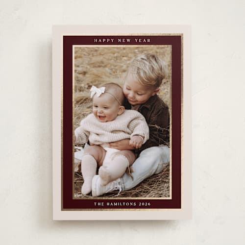 This is a maroon foil pressed holiday cards with foil pressed by Nicole Walsh called encompass printing on recycled smooth signature in standard