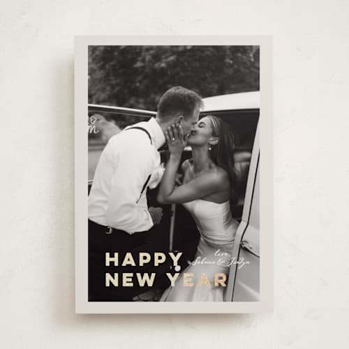 This is a ivory foil pressed holiday cards with foil pressed by Benita Crandall called glittering love printing on recycled smooth signature in standard