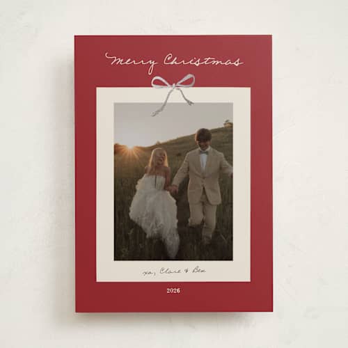 This is a crimson foil pressed holiday cards with foil pressed by Ani Somi called bow on it printing on recycled smooth signature in standard