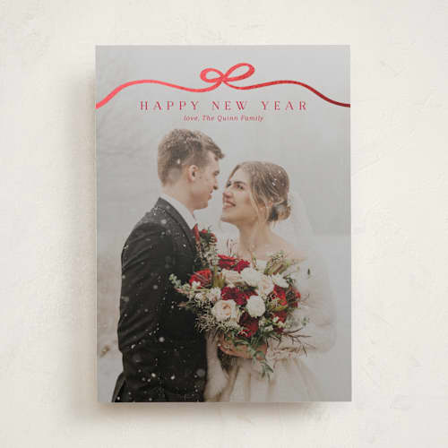 This is a cardinal foil pressed holiday cards with foil pressed by Kaydi Bishop called bow tied printing on recycled smooth signature in standard