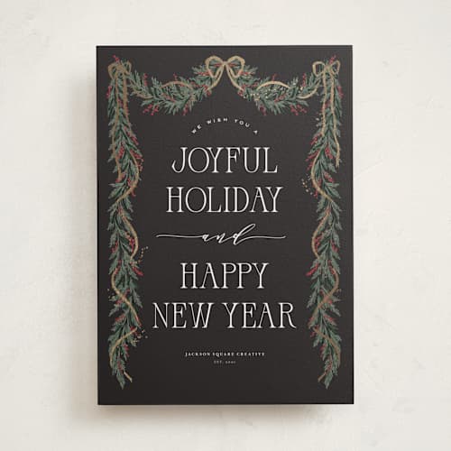 This is a charcoal business holiday cards with foil pressed by Leah Bisch called holly garland printing on signature in standard