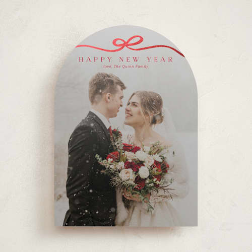 This is a cardinal foil pressed holiday cards with foil pressed by Kaydi Bishop called bow tied printing on recycled smooth signature in standard