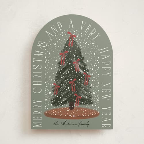 This is a pine non photo holiday cards with standard by Maja Cunningham called snowglobe printing on signature in standard