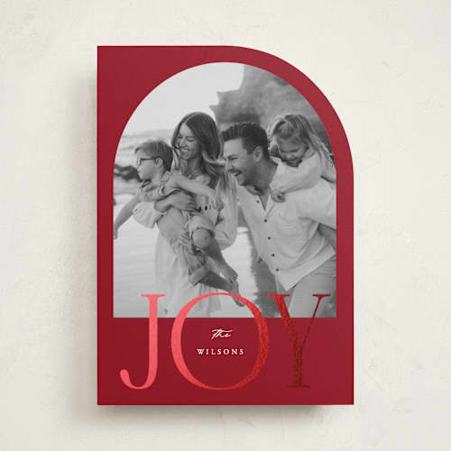 This is a cranberry foil pressed holiday cards with foil pressed by Brianne Larsen called joy arch printing on recycled smooth signature in standard