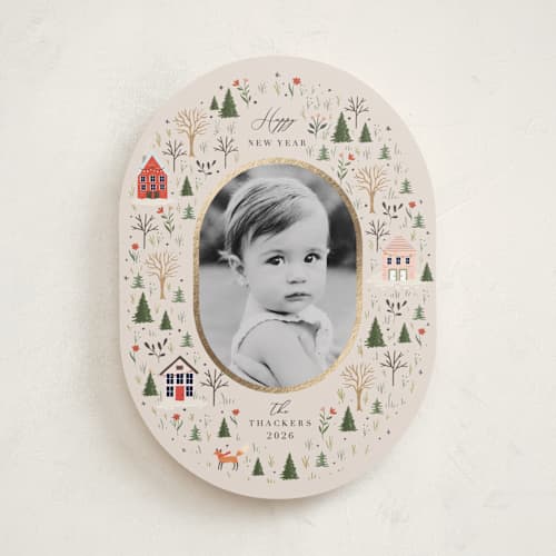 This is a taffy foil pressed holiday cards with foil pressed by Hannah Williams called winter village oval printing on recycled smooth signature in standard