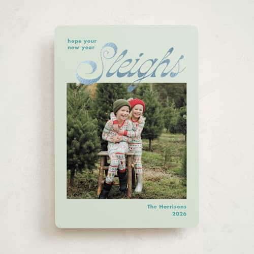 This is a turquoise foil pressed holiday cards with foil pressed by Megan Davis called sleighs printing on recycled smooth signature in standard