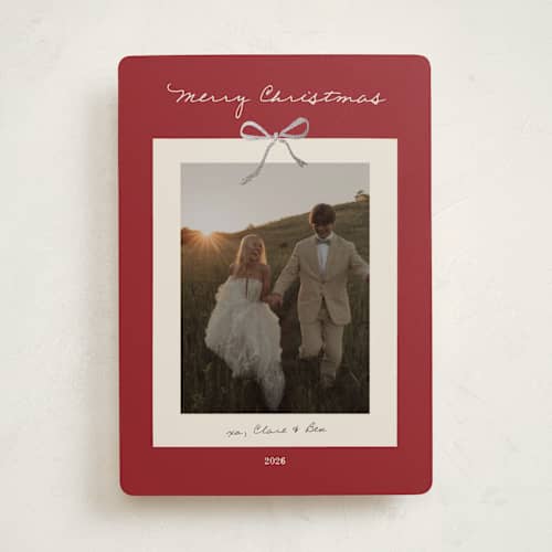 This is a crimson foil pressed holiday cards with foil pressed by Ani Somi called bow on it printing on recycled smooth signature in standard
