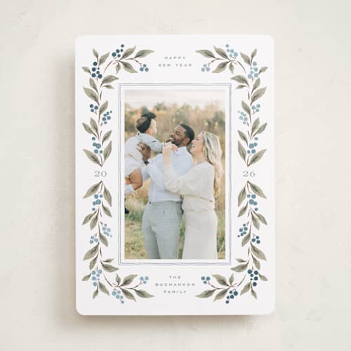 This is a juniper berry foil pressed holiday cards with foil pressed by Wildfield Paper Co called poinsettia + pine printing on recycled smooth signature in standard