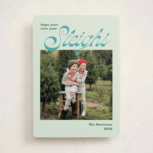 This is a turquoise holiday photo cards with standard by Megan Davis called sleighs printing on recycled smooth signature in standard