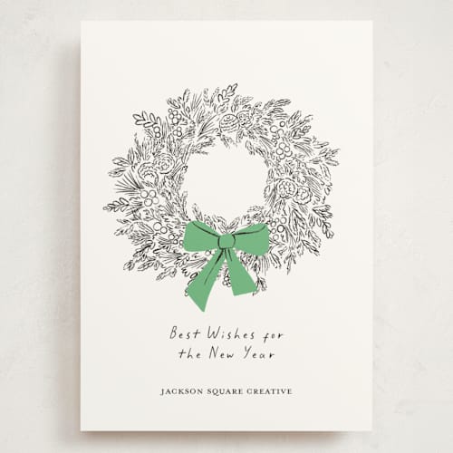 This is a greenery holiday photo cards with standard by mo kelley called wreath with bow printing on signature in grand