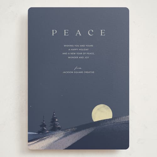 This is a navy holiday photo cards with standard by Eric Ransom called serene peace printing on signature in grand