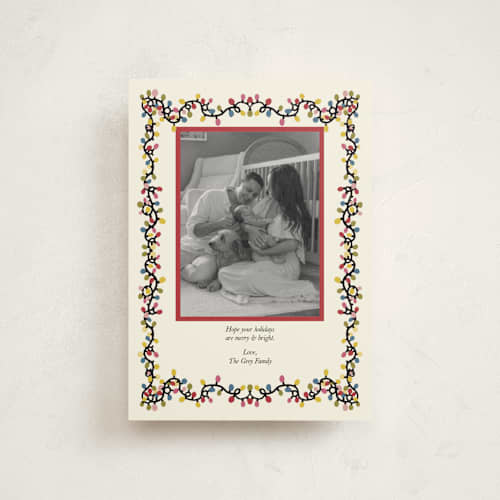 This is a champagne petite holiday cards with standard by Noun New York called merry & bright christmas lights frame printing on signature in petite