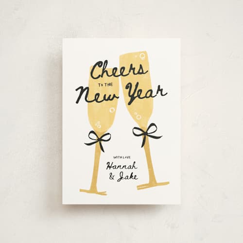 This is a champagne christmas postcards with standard by Kamala Nahas called cheers printing on signature in postcard