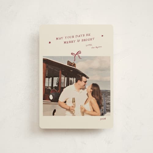 This is a cinnamon petite holiday cards with standard by Ani Somi called merry little bow printing on signature in petite