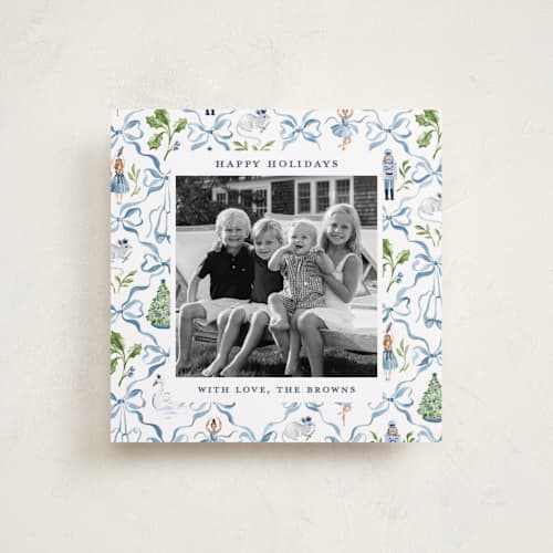 This is a blue ribbon holiday photo cards with standard by Sarah Knight called nutcracker ribbons printing on recycled smooth signature in square