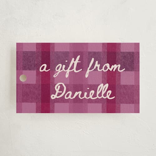 This is a raspberry gift tags with standard by Carrie Moradi called cozy checked plaid printing on signature in tag