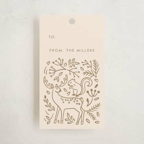 This is a golden gift tags with standard by Teju Reval called enchanted holiday printing on signature in tag