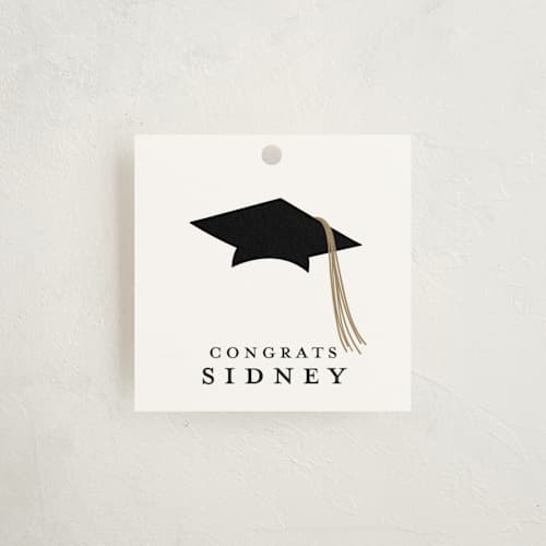 This is a cotton graduation tags with standard by Stacey Meacham called cap and year printing on signature in tag