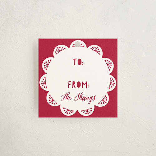 This is a carmine gift tags with standard by Olivia Raufman called holiday charm printing on signature in tag