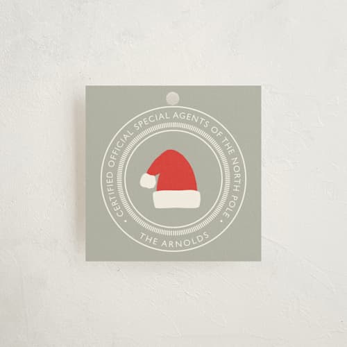 This is a pewter gift tags with standard by Alston Foster called north pole certified printing on signature in tag