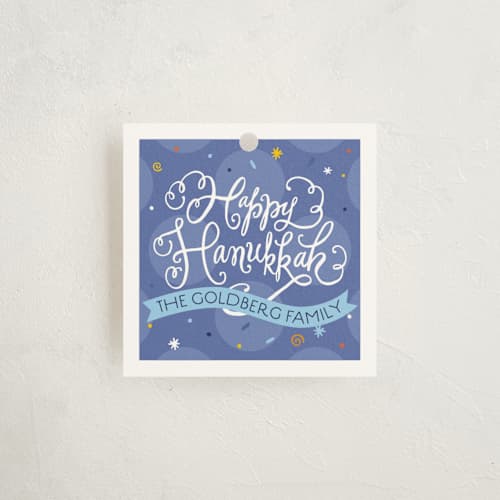 This is a periwinkle gift tags with standard by Laura Bolter called joyful hanukkah printing on signature in tag