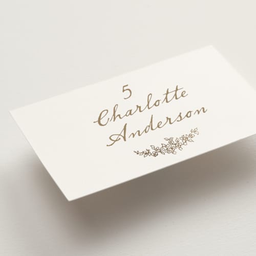 This is a ivory wedding place cards with foil pressed by Cass Loh called boho flower crest printing on signature in placecard