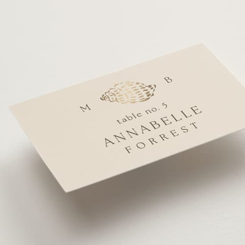 This is a champagne wedding place cards with foil pressed by Griffinbell Paper Co. called seaside printing on signature in placecard