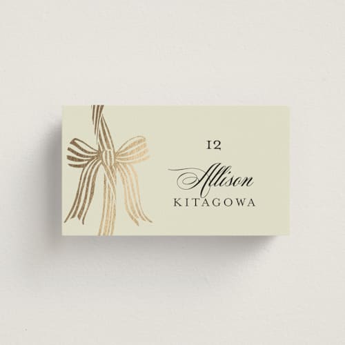 This is a champagne wedding place cards with foil pressed by Chris Griffith called all tied up printing on signature in placecard