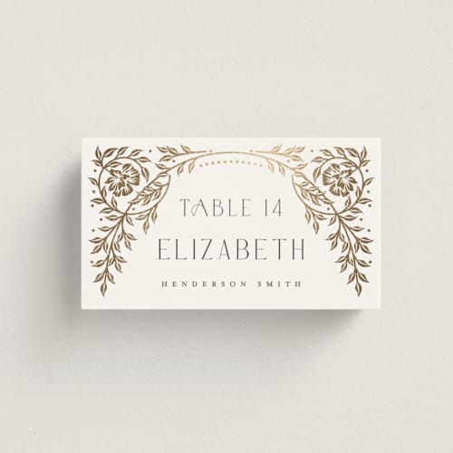 This is a ivory wedding place cards with foil pressed by Ana de Sousa called gilded nouveau frame printing on signature in placecard