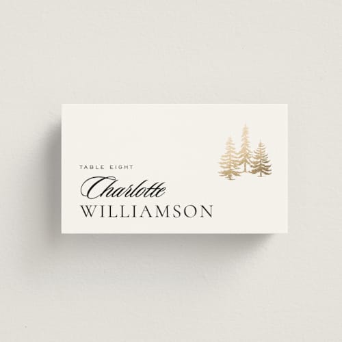 This is a snow wedding place cards with foil pressed by Stacy Maalouf called gilded forest printing on signature in placecard