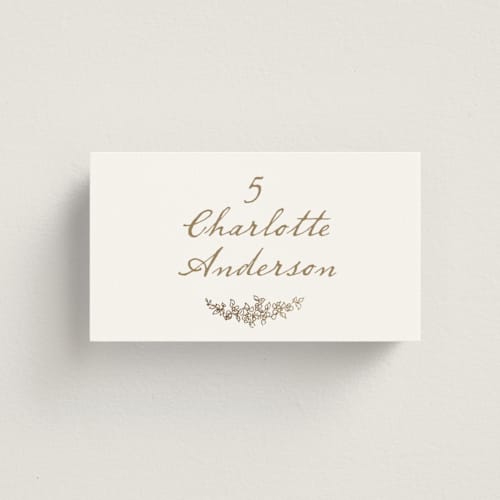 This is a ivory wedding place cards with foil pressed by Cass Loh called boho flower crest printing on signature in placecard