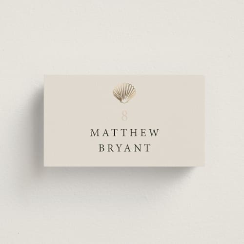 This is a sand wedding place cards with foil pressed by Hannah Bowman called simple seashell printing on signature in placecard